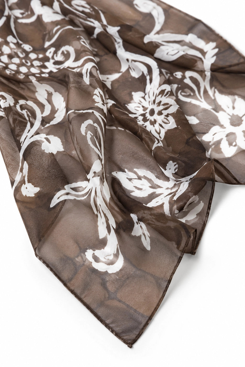 A sheer brown scarf with a white damask floral pattern, draped on a clean white background.