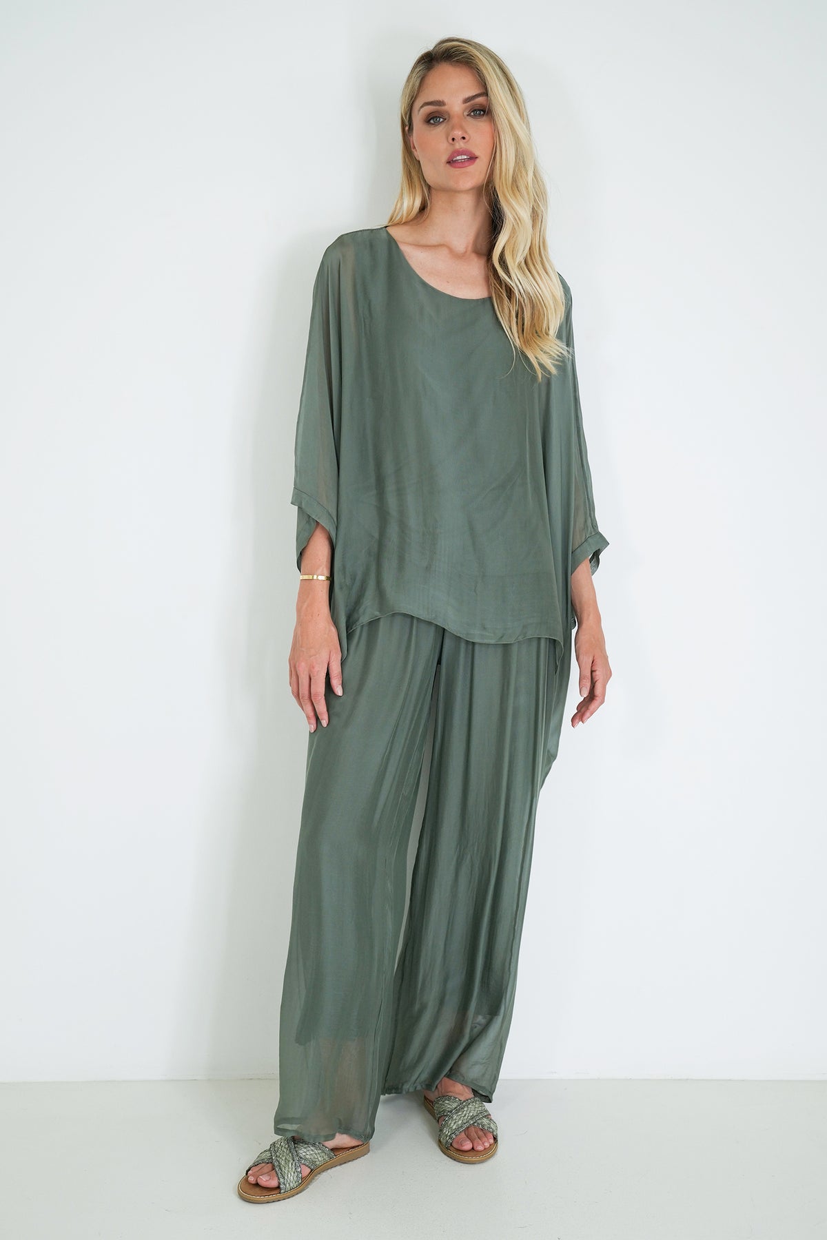 Woman wearing a green outfit against a white background