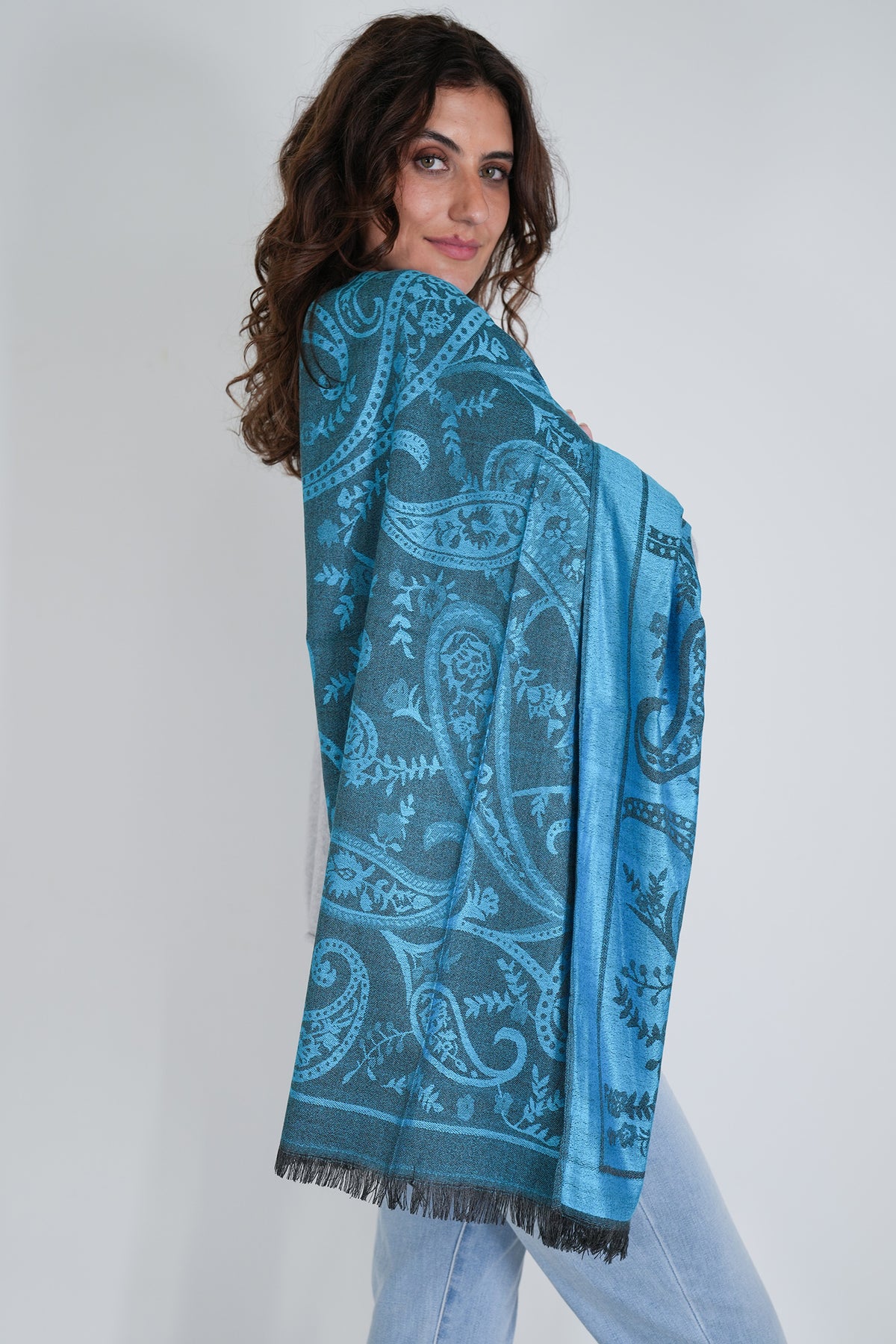 Woman wearing a blue patterned scarf on a white background