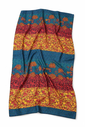 A rectangular textile item, likely a scarf or throw blanket, featuring a horizontal striped pattern with teal blue, red, and yellow floral and ornamental bands, shown against a plain white background.