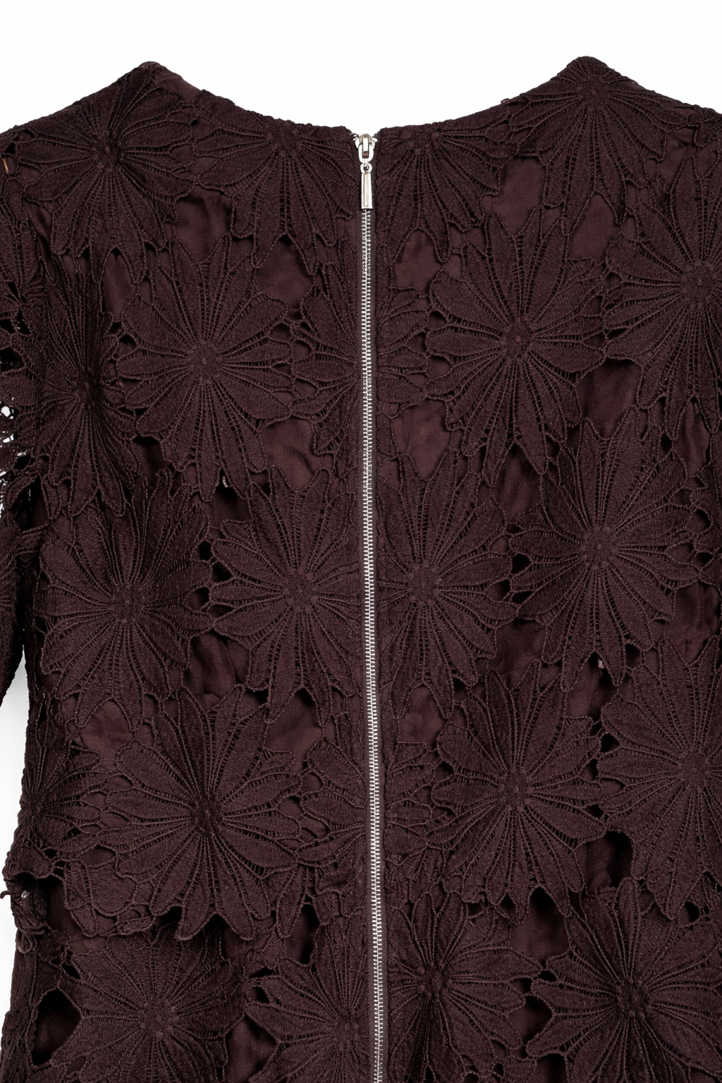Close-up of a dark brown lace garment with a zipper.