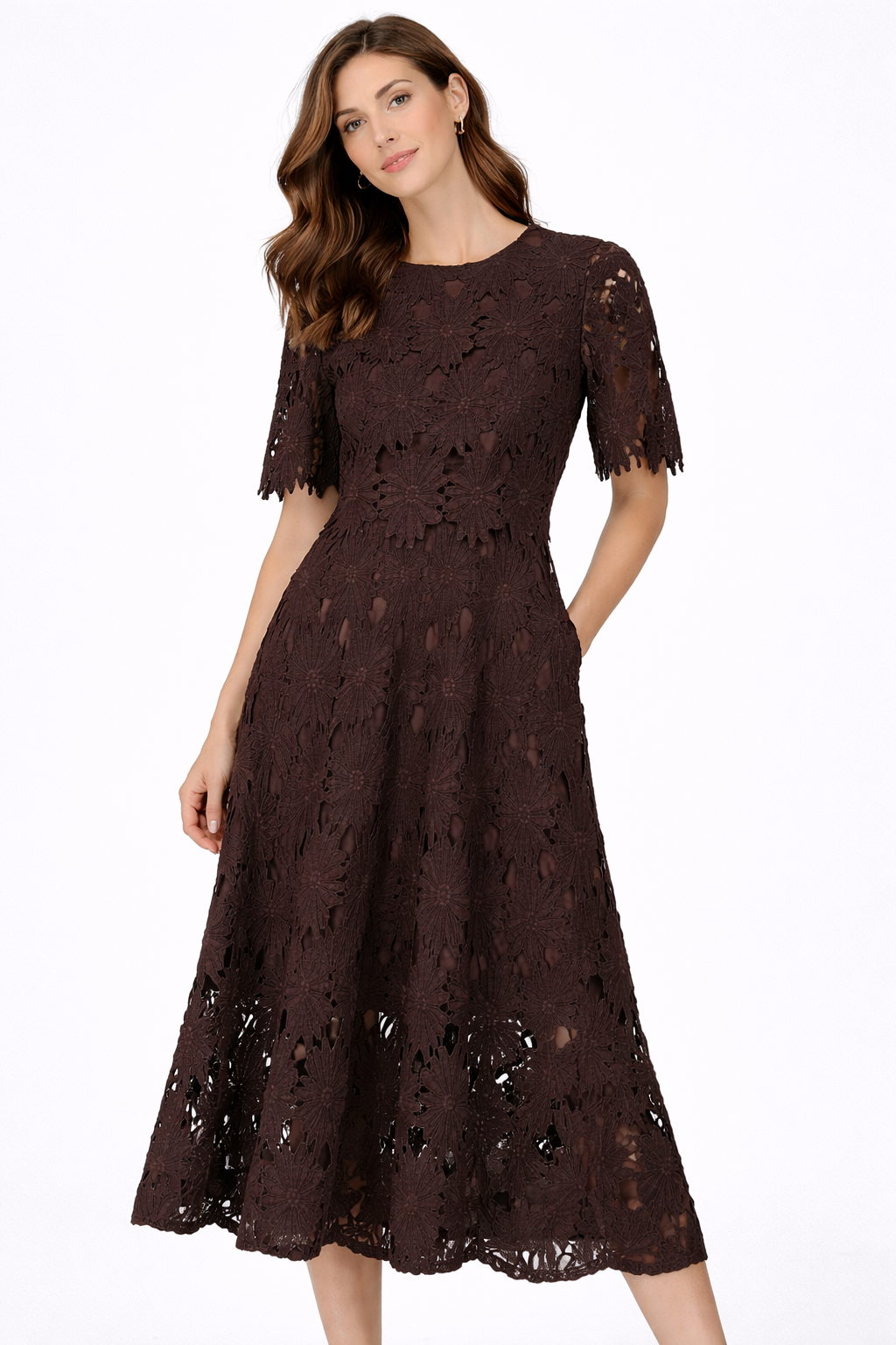 Woman wearing a brown lace dress on a white background