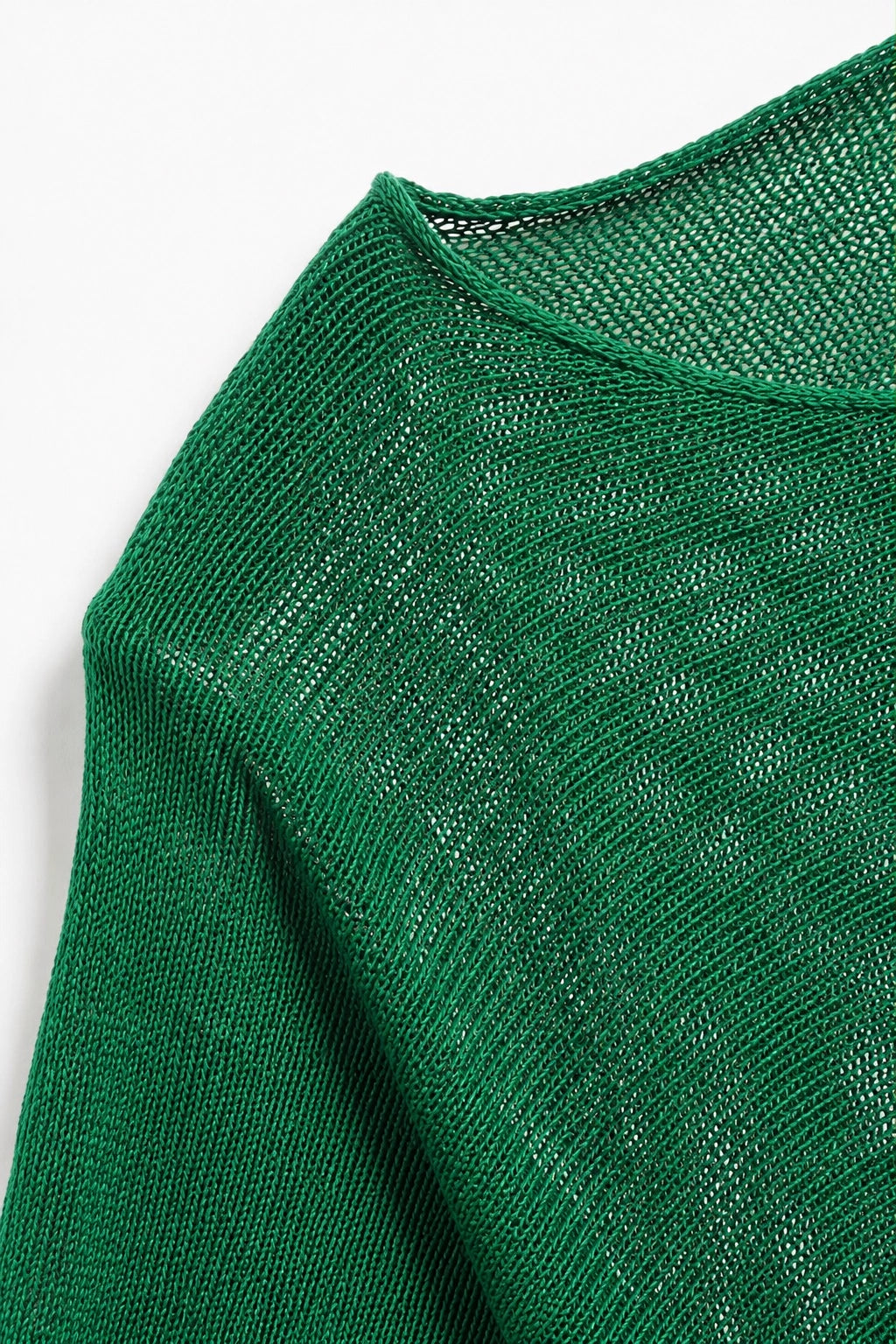 Close-up of a green knit sweater showing the textured fabric and crew neckline on a white background.