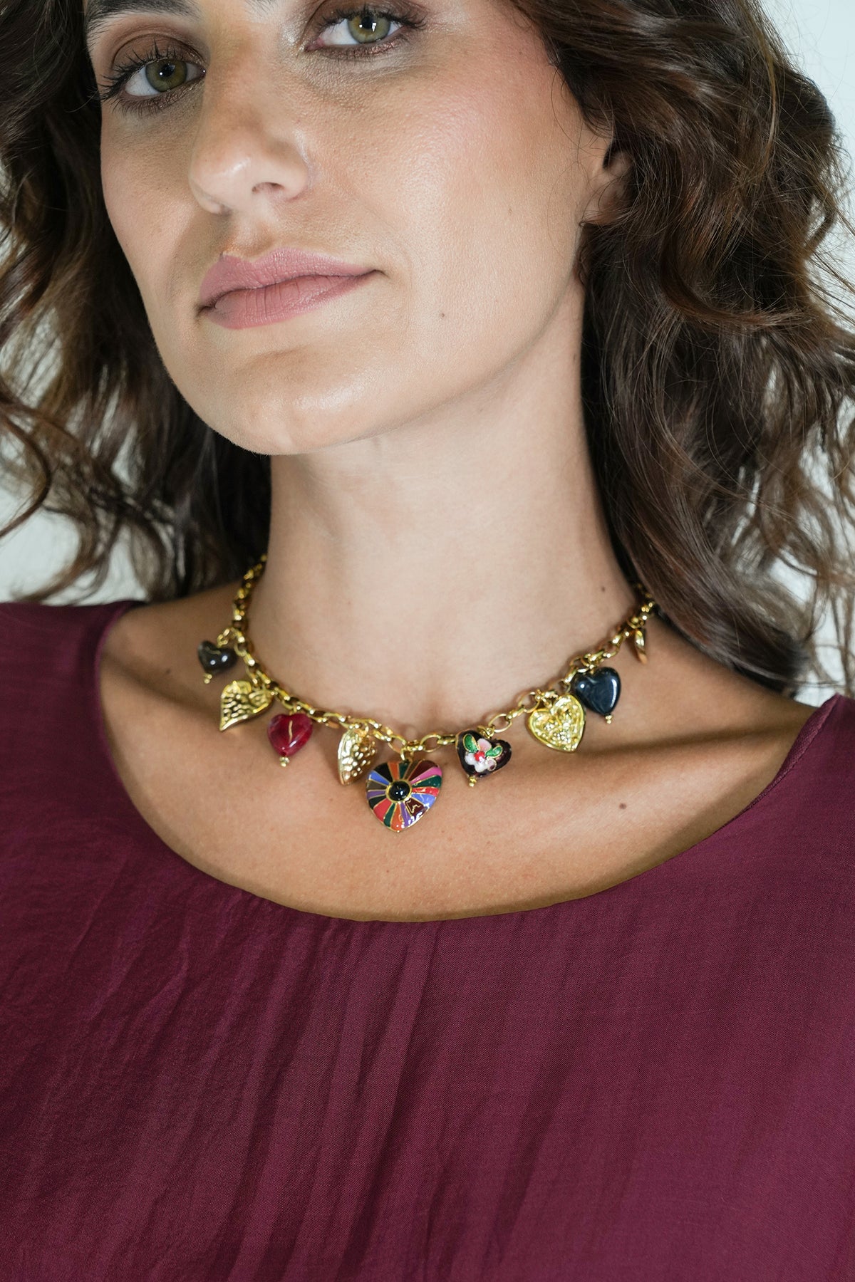 Woman wearing a colorful necklace with heart-shaped pendants.