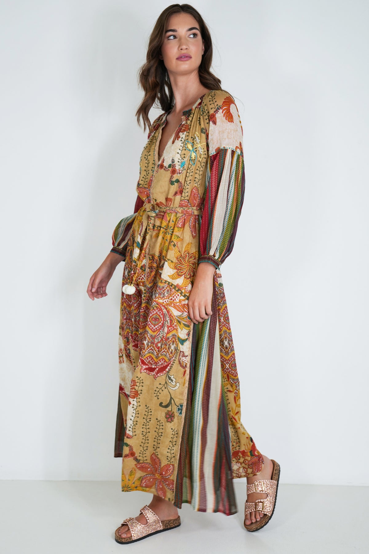 Woman wearing a colorful patterned dress on a white background
