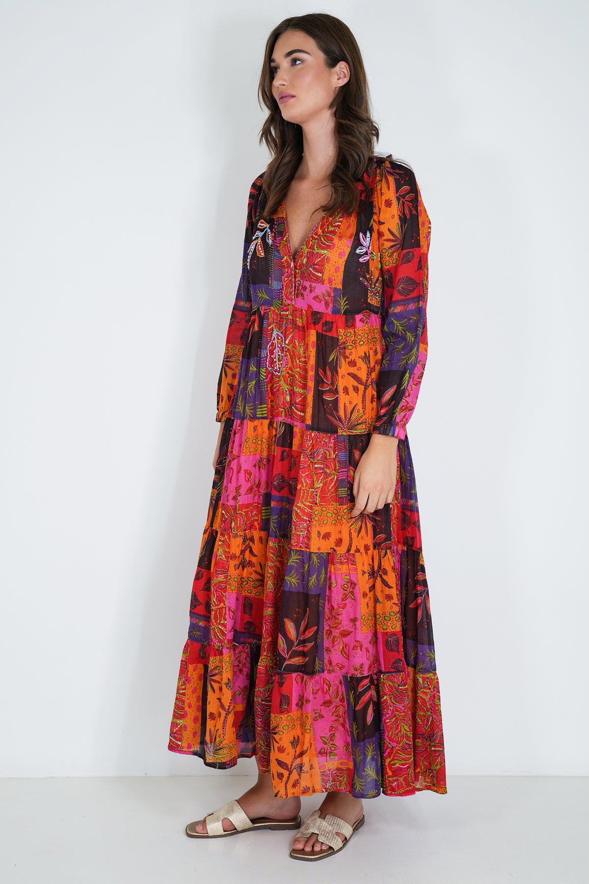 Woman wearing a colorful patchwork dress on a white background