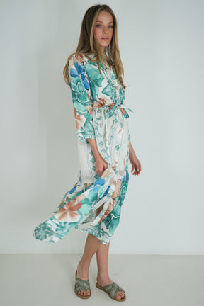 Woman wearing a floral dress against a white background