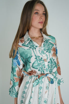 Woman wearing a floral dress with a plain background