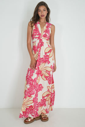 Woman wearing a floral dress with pink and beige patterns on a white background