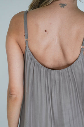 Gray tank top worn by a person on a plain background