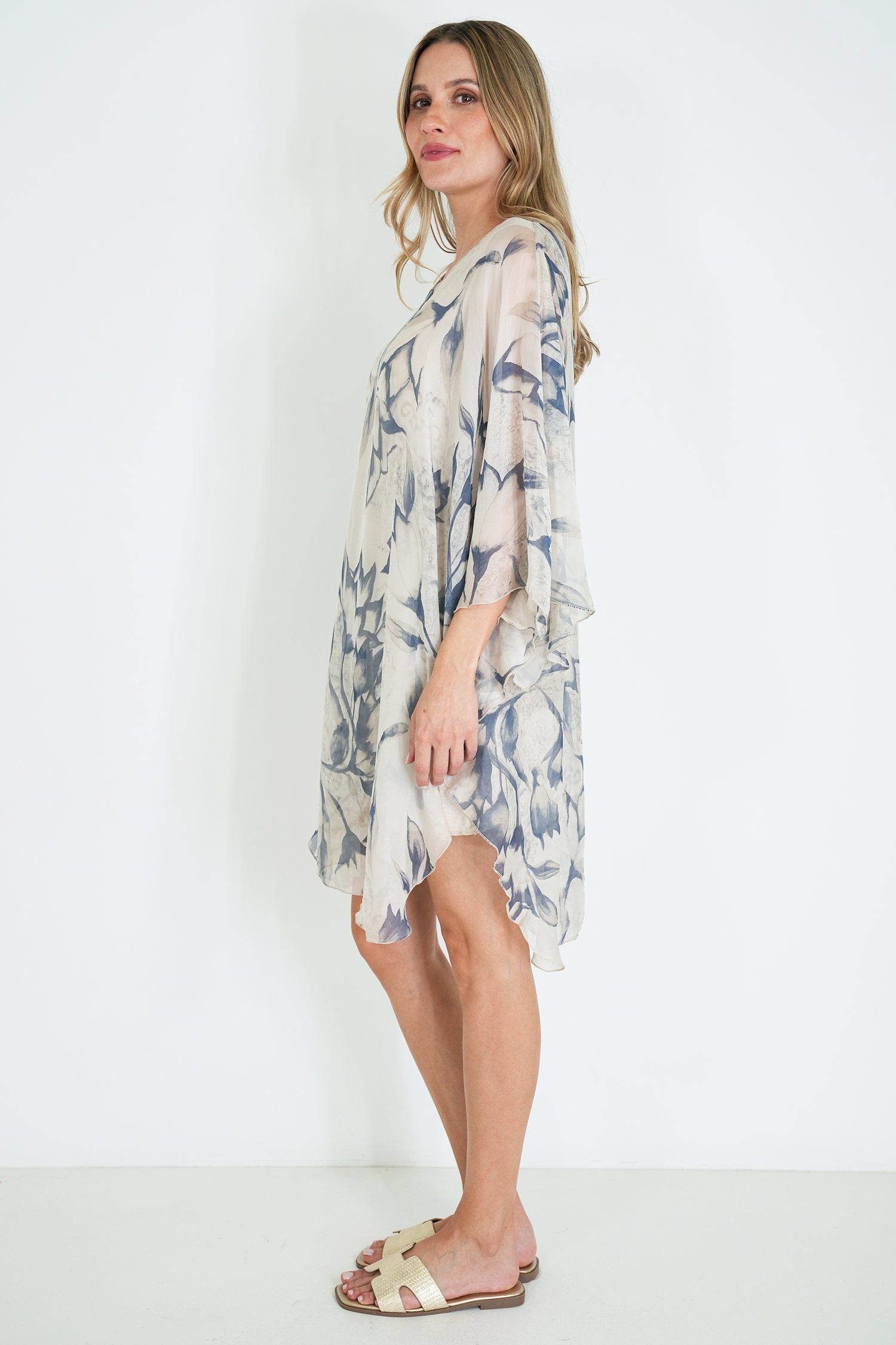 Woman wearing a floral dress against a white background