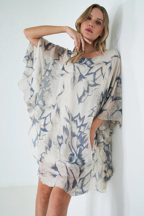 Woman wearing a floral patterned dress against a white background