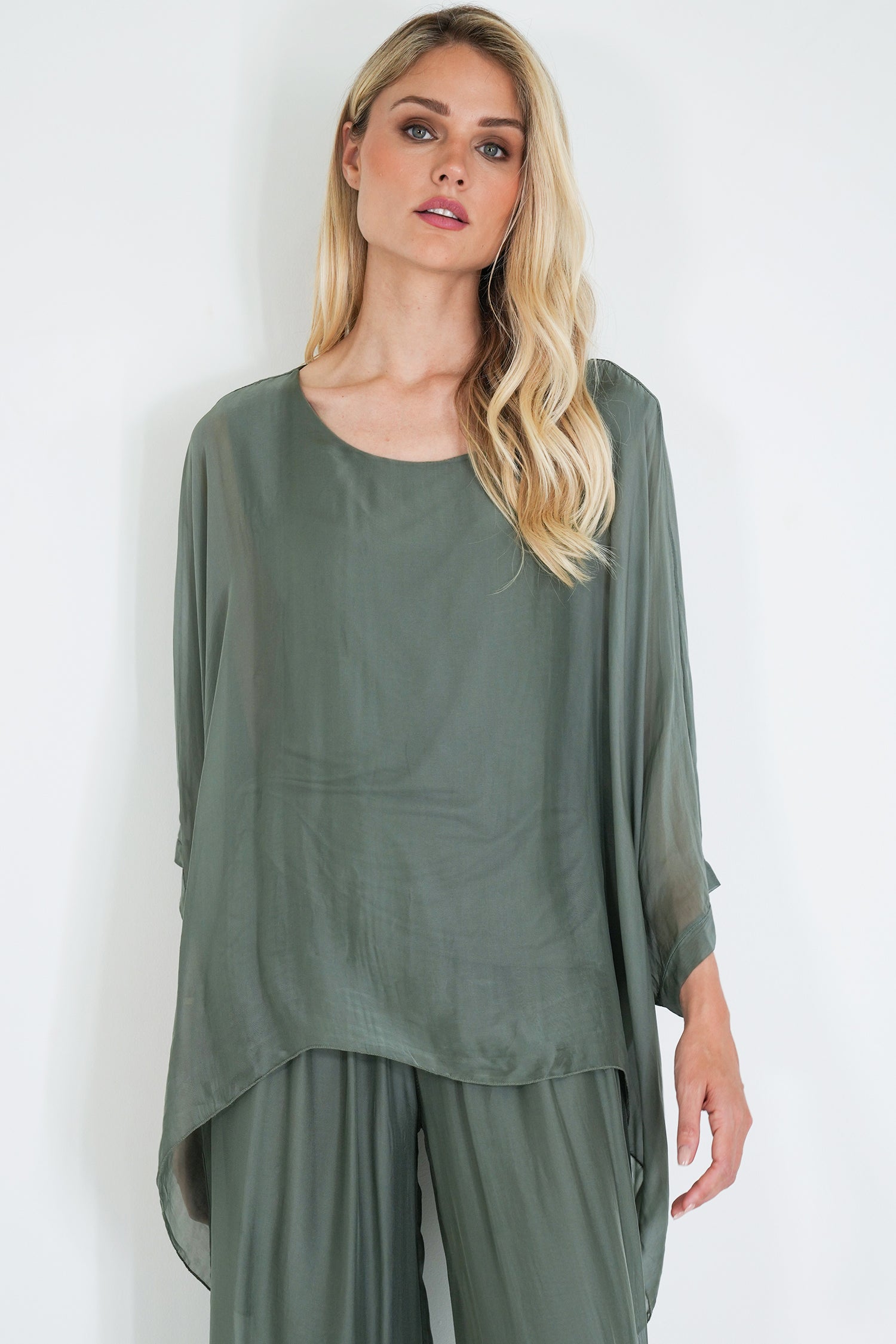 Woman wearing a green outfit against a white background