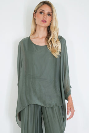 Woman wearing a green outfit against a white background