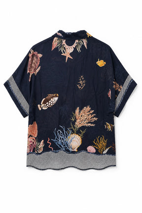 A short-sleeve button-up shirt in dark navy blue, featuring an all-over embroidered underwater theme with fish, seashells, coral, and seaweed in muted beige, brown, and blue tones. The shirt has a textured gray hem and sleeve cuffs.