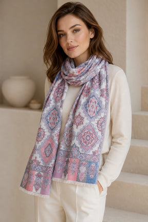 Woman wearing a patterned scarf in an indoor setting