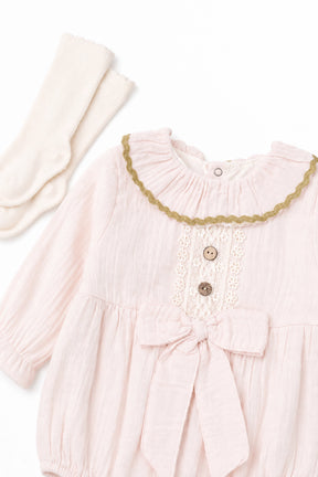 Pink baby dress with lace trim and buttons, paired with a matching headband on a white background