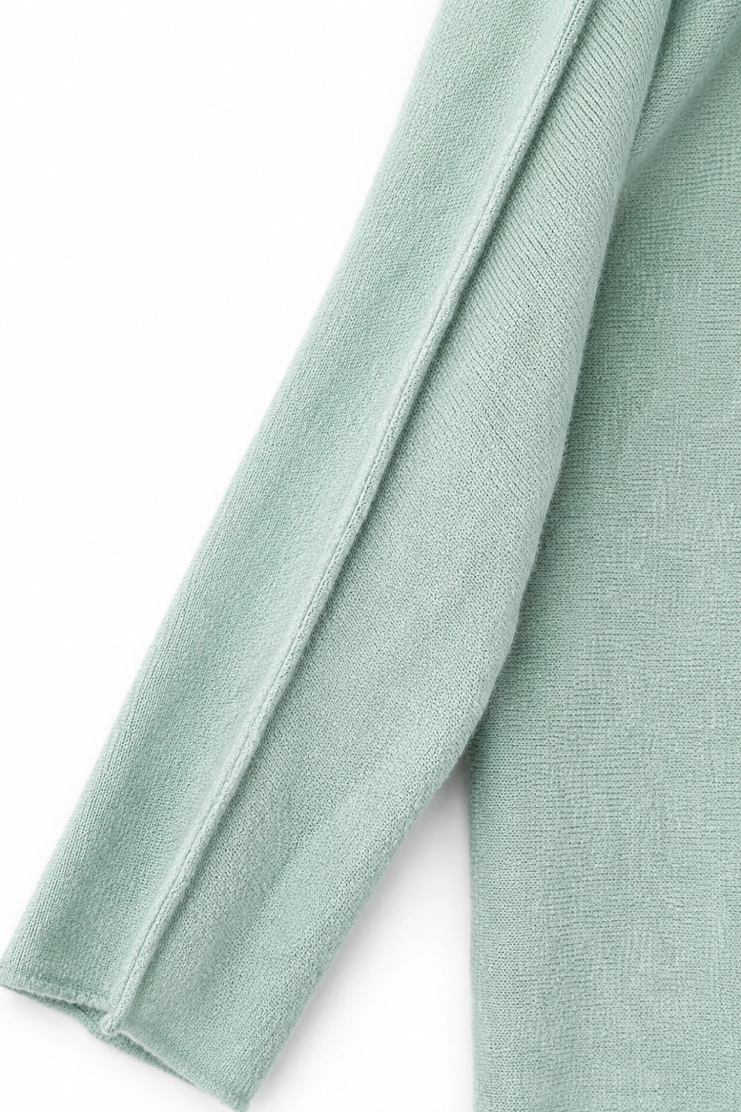 Close-up of light green fabric on a white background
