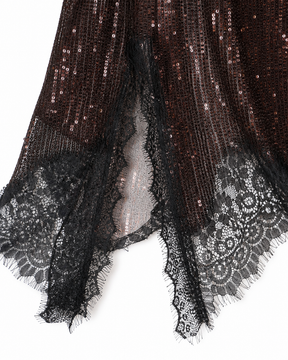 Close-up of a brown and black lace garment on a white background