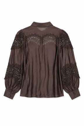 Brown blouse with lace and embellishment details on a white background