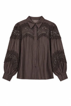 Brown blouse with lace and embellishment details on a white background