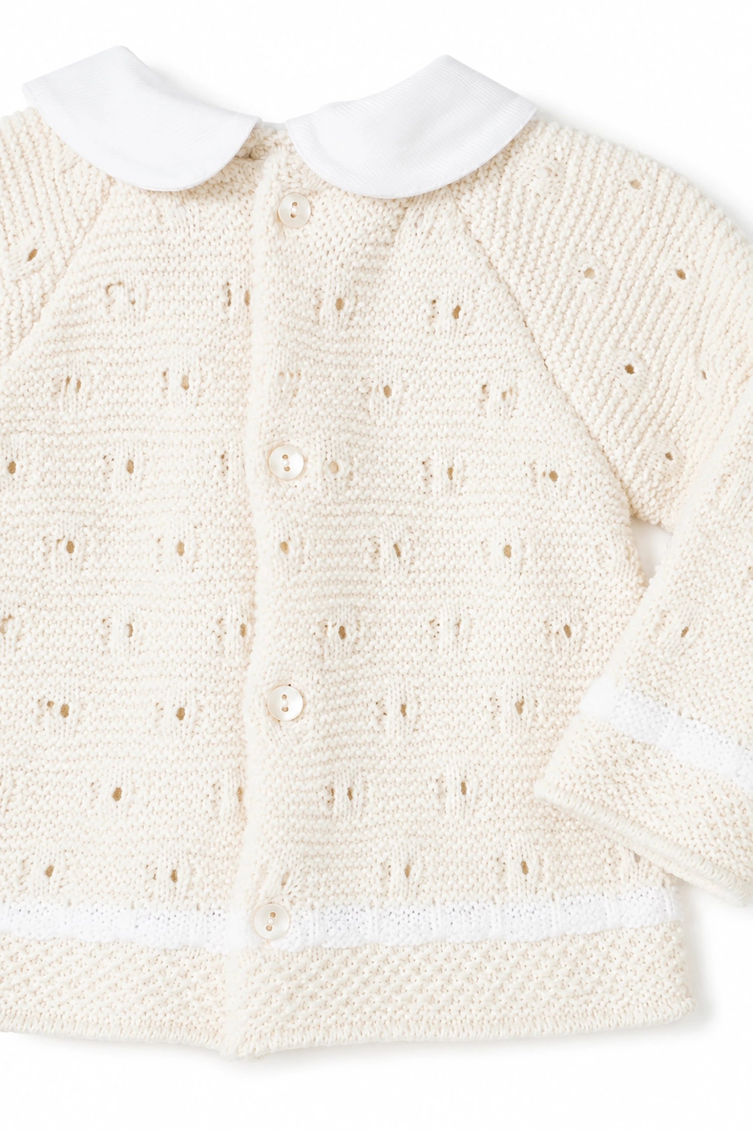 Cream-colored knitted cardigan with white collar on a white background