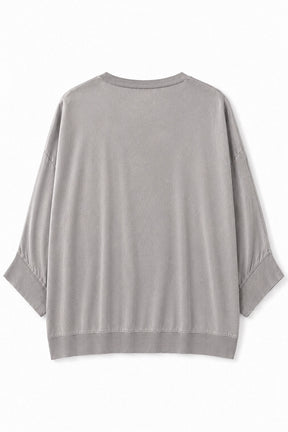 A light gray knit top with three-quarter sleeves and ribbed cuffs, shown from the back on a white background.