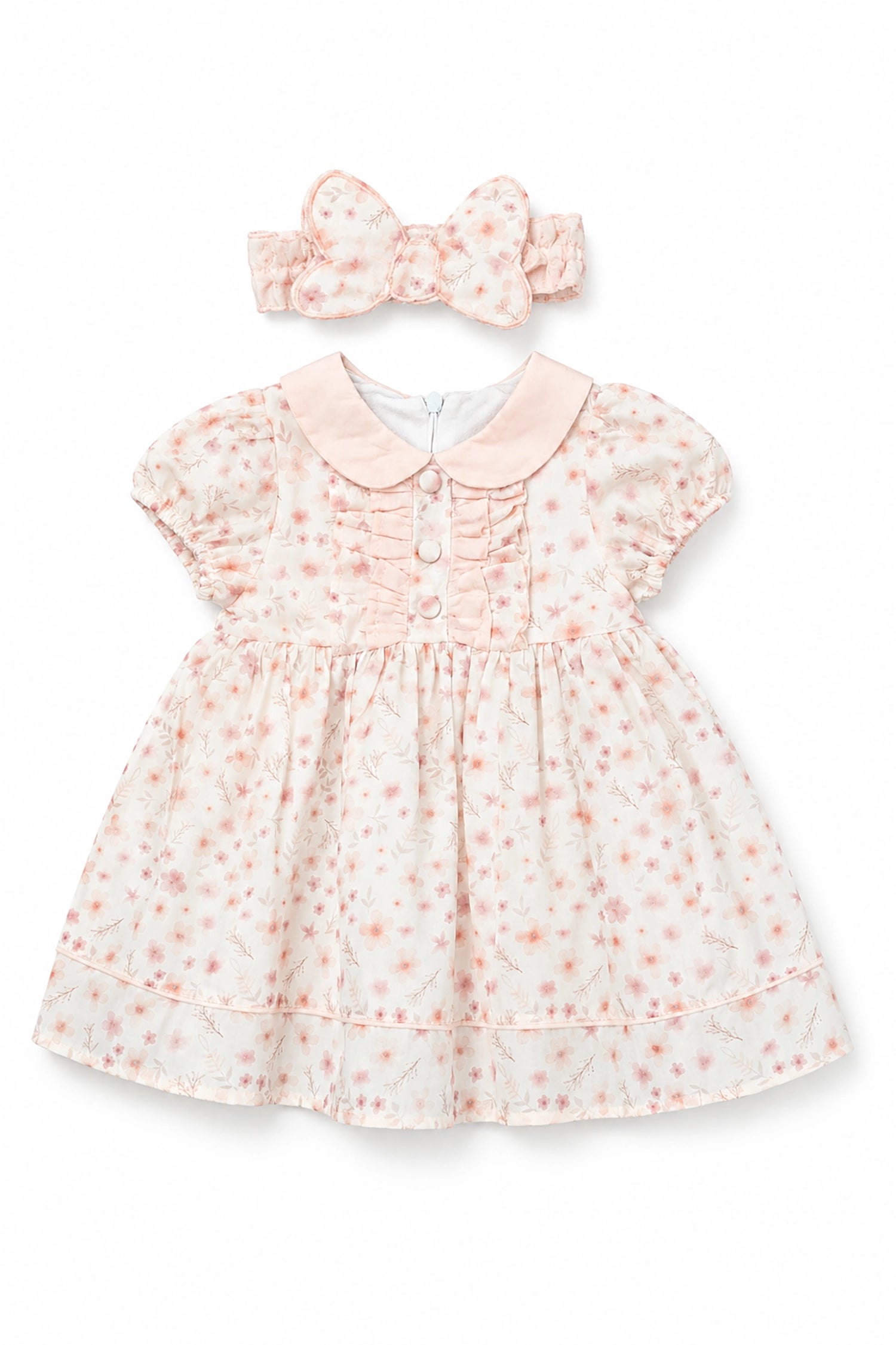 Baby dress with floral pattern and matching headband on a white background