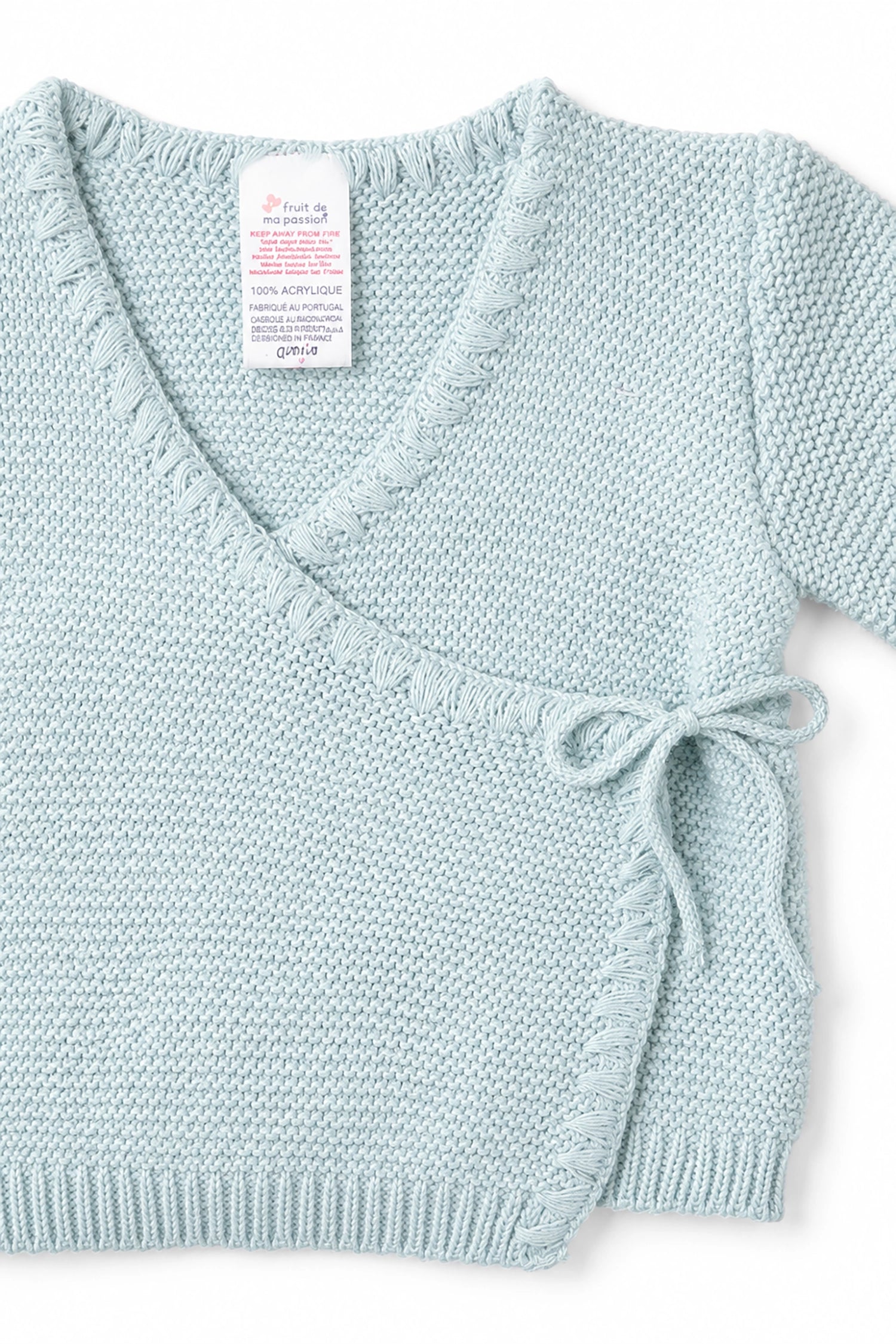 Light blue knitted cardigan with a bow detail on a white background