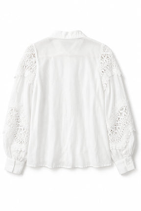 White blouse with lace details on a white background